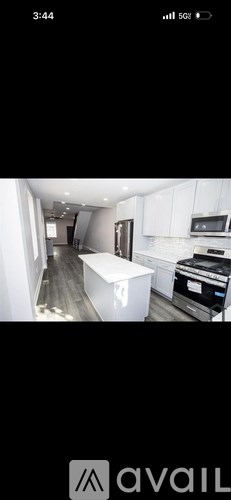 A modern kitchen with white cabinets and a central island.