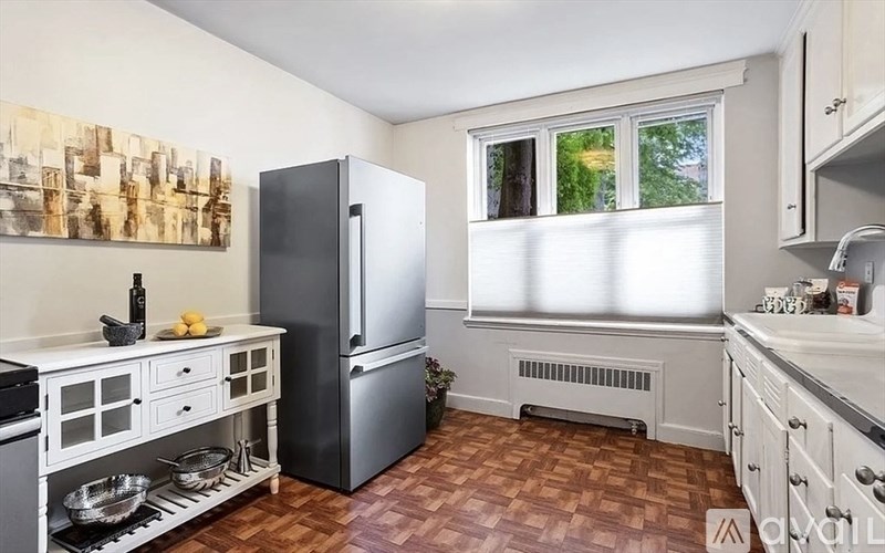 A kitchen with a refrigerator, stove, and sink.