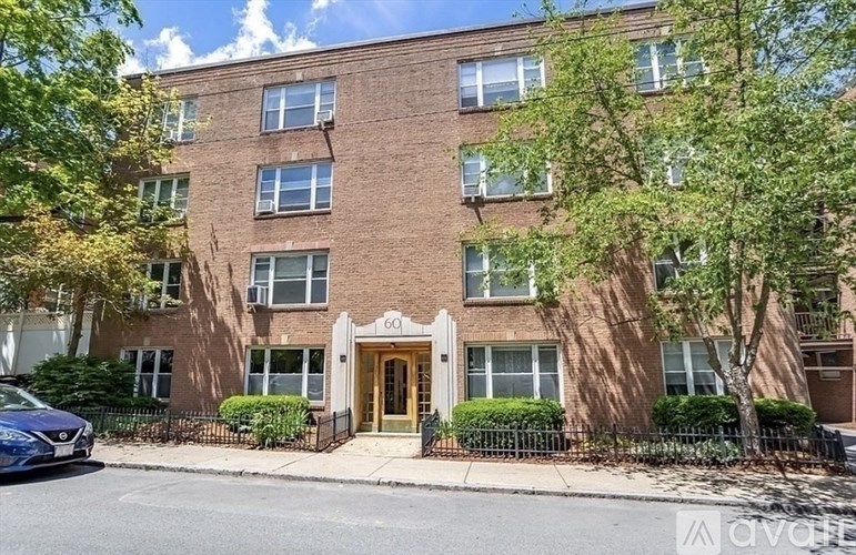 A street view of apartment building number 601 with a blue car parked in front.