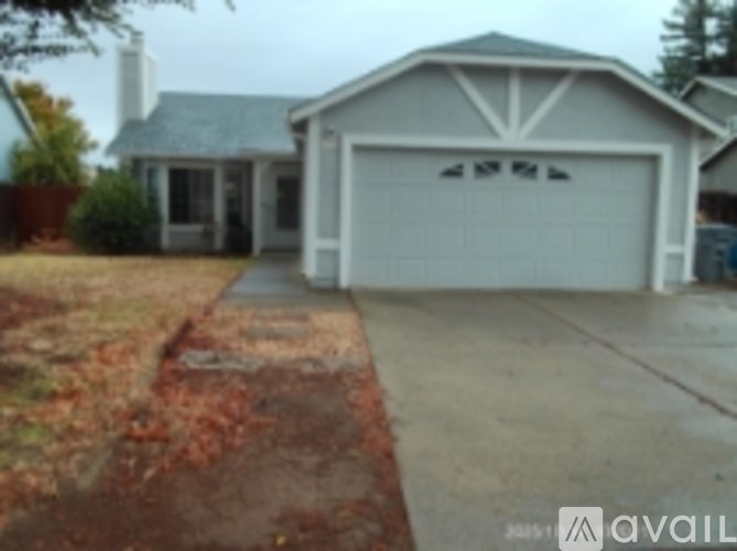 A house with a white garage door and a driveway.