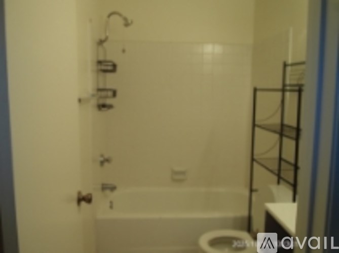 A bathroom with a toilet, sink and bathtub.