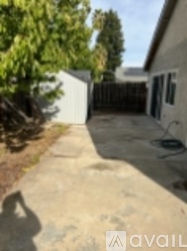A concrete pathway leads to a white garage.