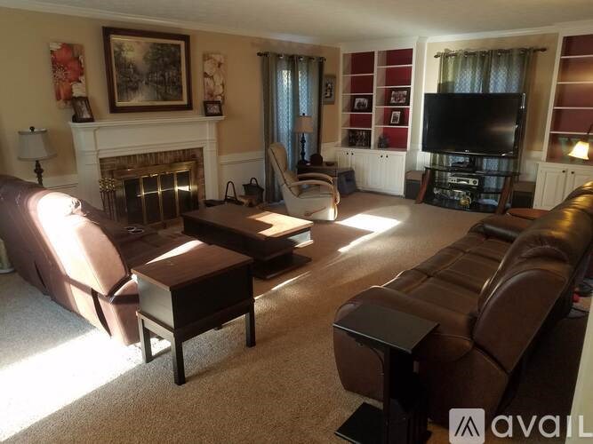 A living room with a fireplace and a television.
