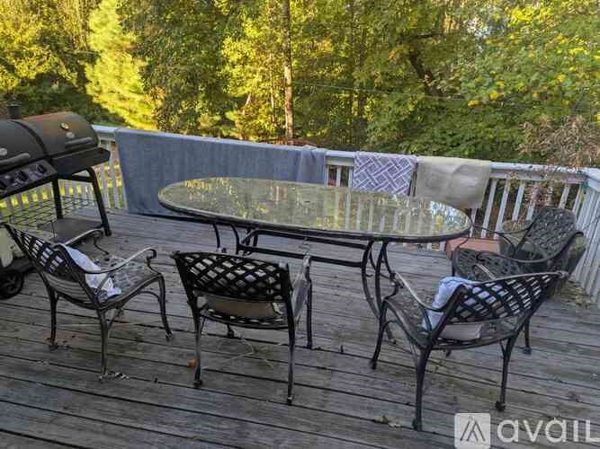 A bathroom with a white toilet and a white sink with a cabinet above it.