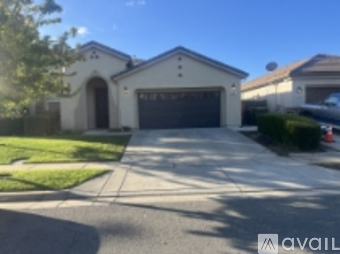 A house with a garage and a driveway in front.