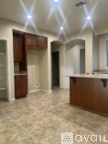 A kitchen with a brown counter top and cabinets.