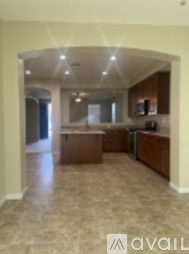 A kitchen with brown cabinets and a tiled floor.