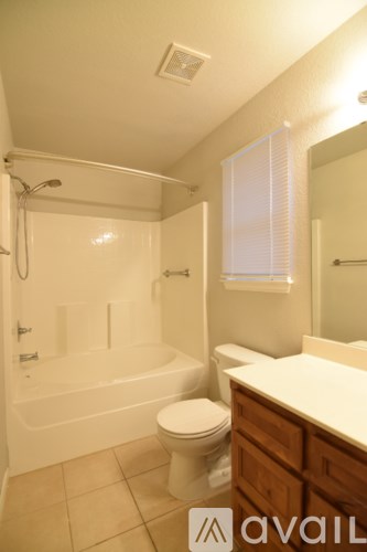 A bathroom with a toilet, sink, and bathtub.