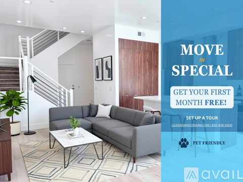 A living room with a couch, coffee table, and staircase.