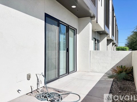 A modern house with a white exterior and a glass door.
