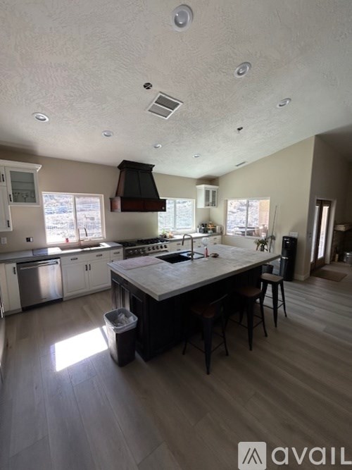 A kitchen with a large island and modern appliances.