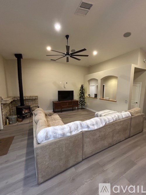 A living room with a fireplace and a Christmas tree.