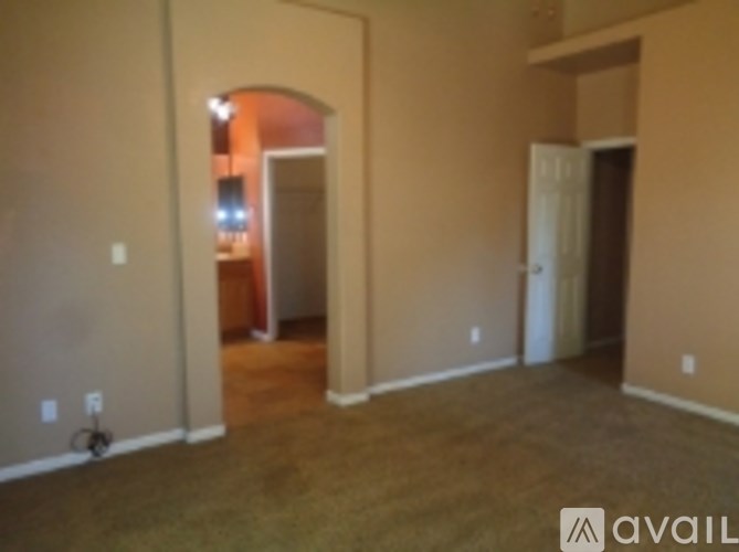 A room with beige walls and a brown carpet.