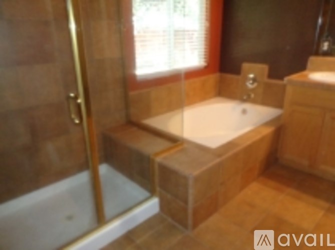 A bathroom with a tub and a shower.