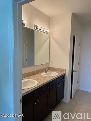 A bathroom with a sink and mirror.