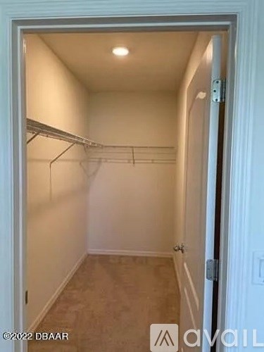 A white door with a small hallway visible through the door.