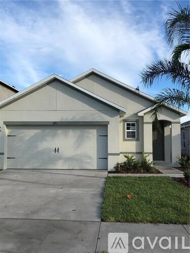 A two-story house with a garage and a driveway.