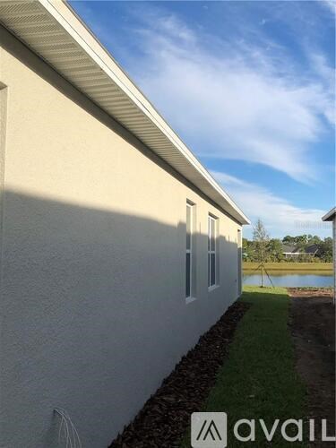 A house with a white exterior and a small garden area.