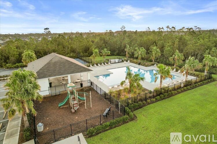 A backyard with a pool and slide.