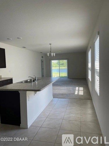 A kitchen with a sink and a window.