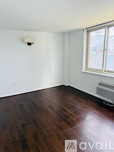 A room with wooden floors and a window.