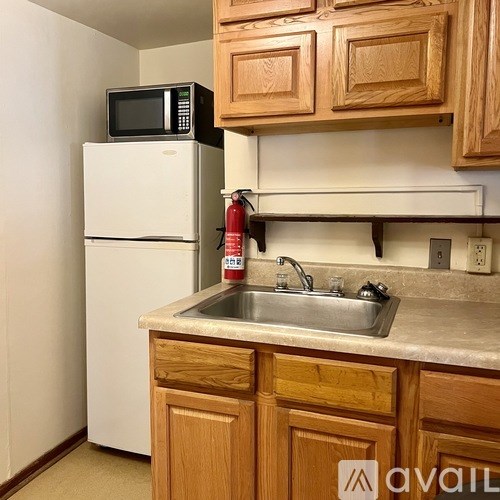 A kitchen with wooden cabinets and a white refrigerator.