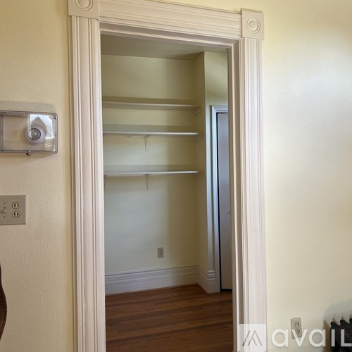 A white door with a mirror on the wall.