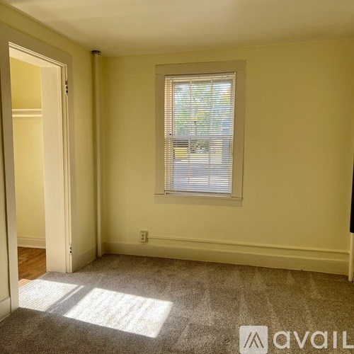 A room with a window and a door.