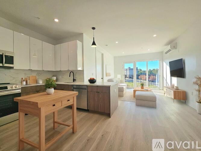 A kitchen with wooden floors and white cabinets is available for rent.