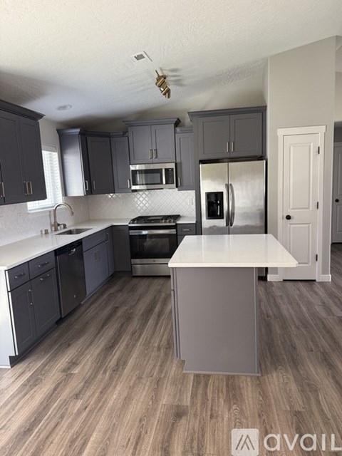 A kitchen with dark wood cabinets and a white island.