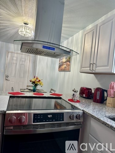 A kitchen with a stove top oven and a range hood.