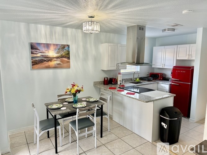 A kitchen with a dining table set for four.