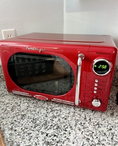 A red Nostalgia toaster oven is set to 2:58 minutes.