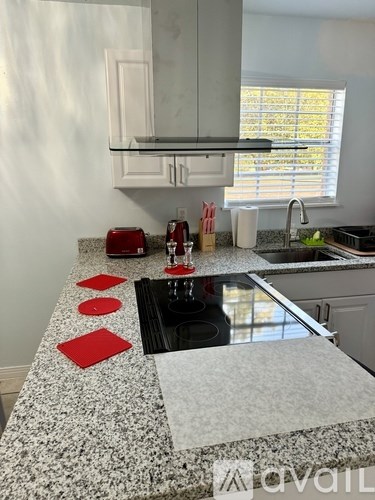 A kitchen with granite countertops and a black sink.