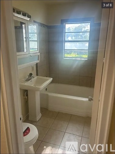 A bathroom with a toilet, sink, and bathtub.