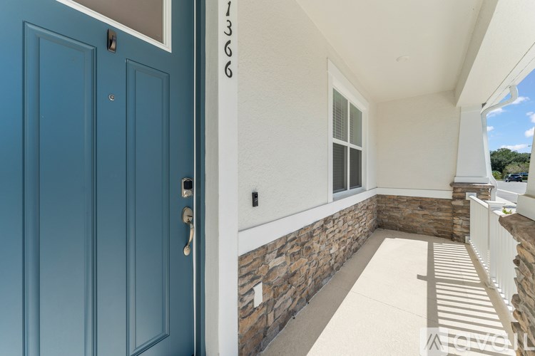 A blue door with a white wall and a window.