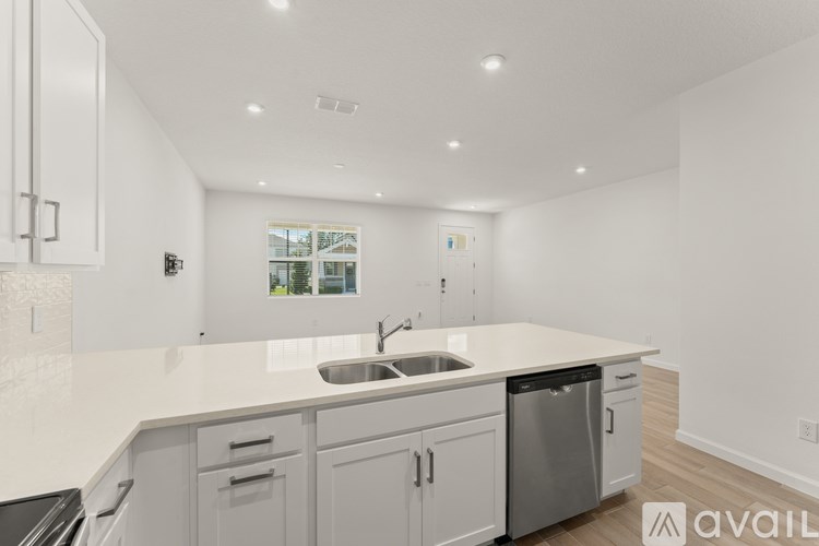 A modern kitchen with white cabinets and a large island.