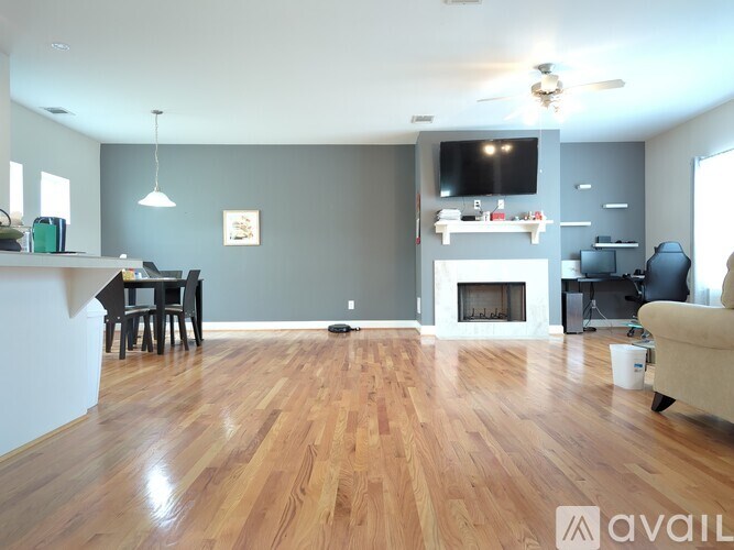 A living room with a fireplace and a television.