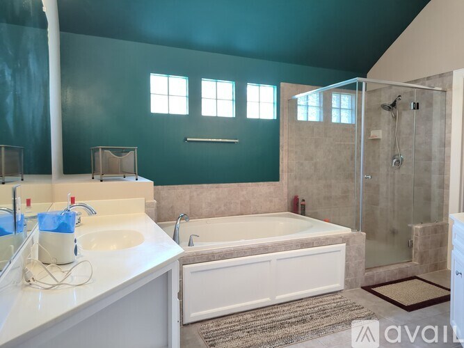 A bathroom with a white sink and a white bathtub.