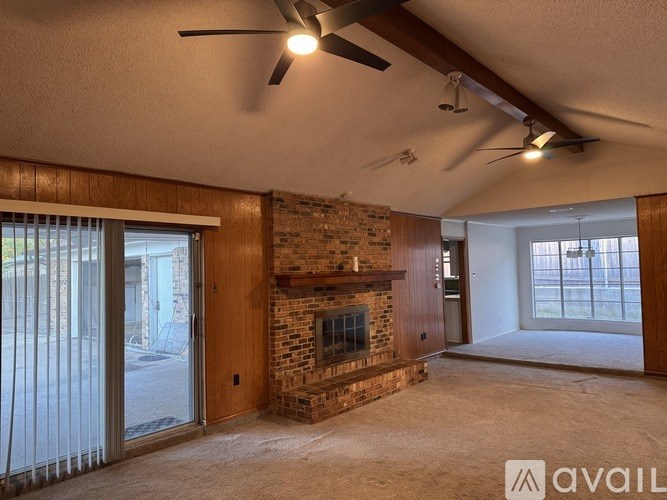 A living room with a fireplace and sliding glass doors.