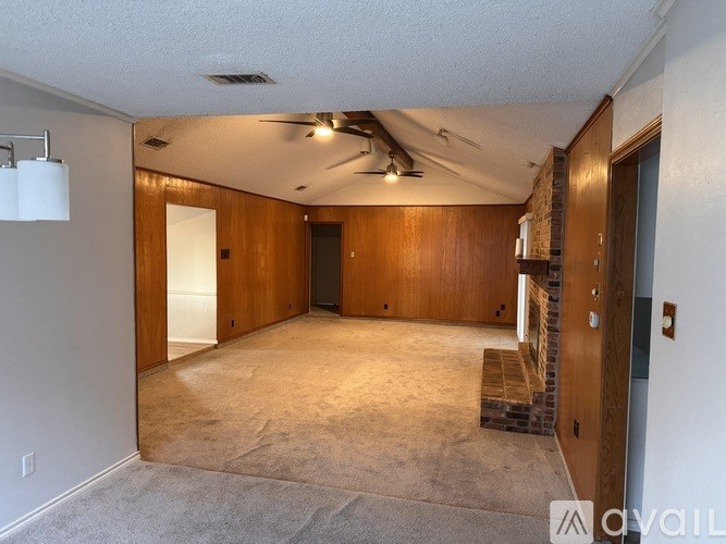 A room with wooden walls and a carpeted floor.