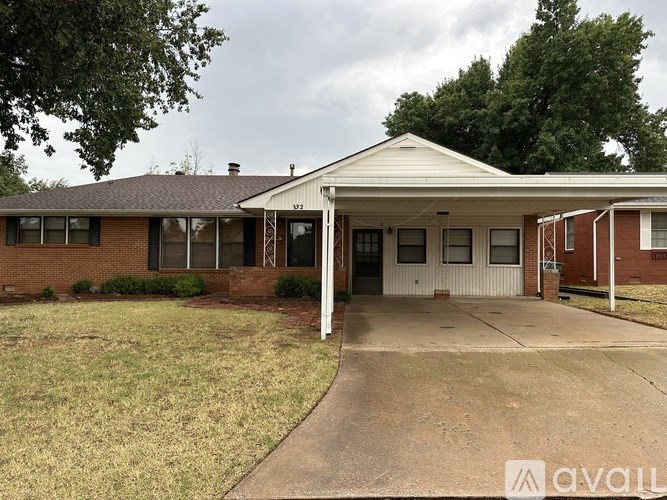 A white house with a brick facade and a covered porch.