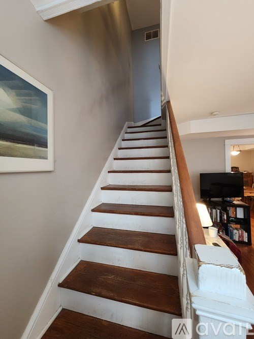 A staircase with wooden steps and white railings.