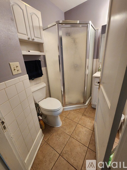 A bathroom with a toilet, sink, and shower.