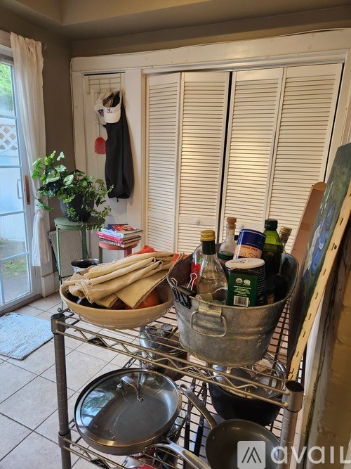 A kitchen with a metal pan on the stove and a bucket of food on the counter.