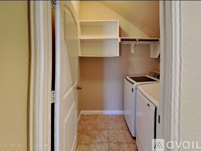 A small kitchen with a washing machine and a refrigerator.
