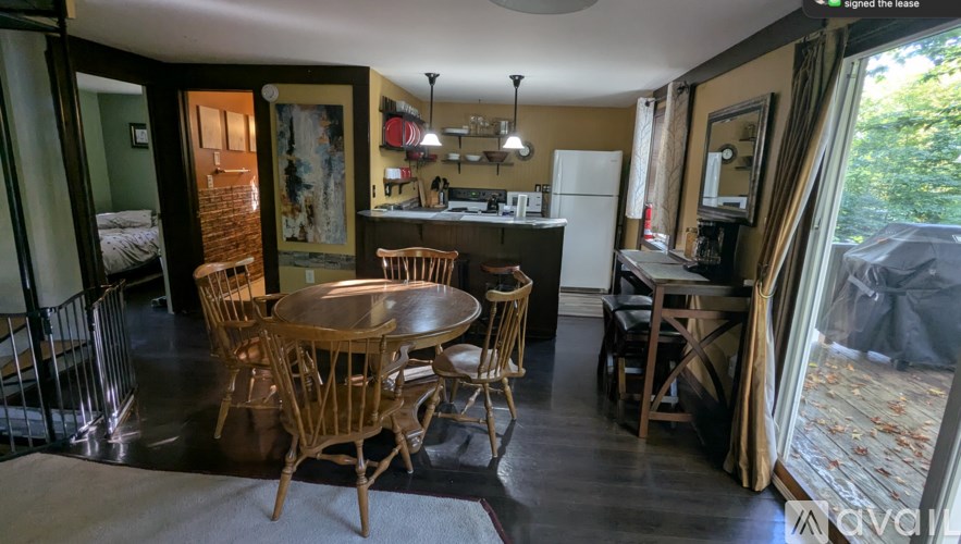 A dining room with a round table and chairs.
