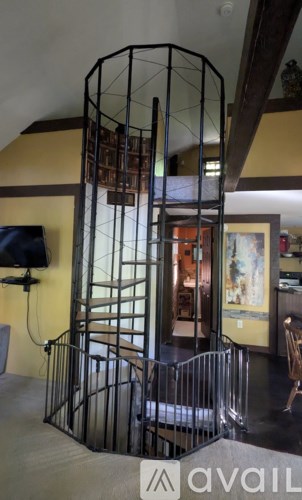 A large metal cage with bars on the sides and a door in the middle.