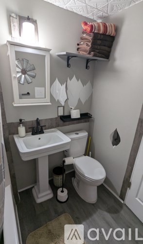 A small bathroom with a white sink and toilet.