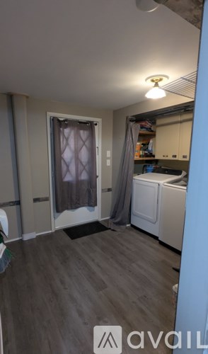 A room with a washing machine and a window.